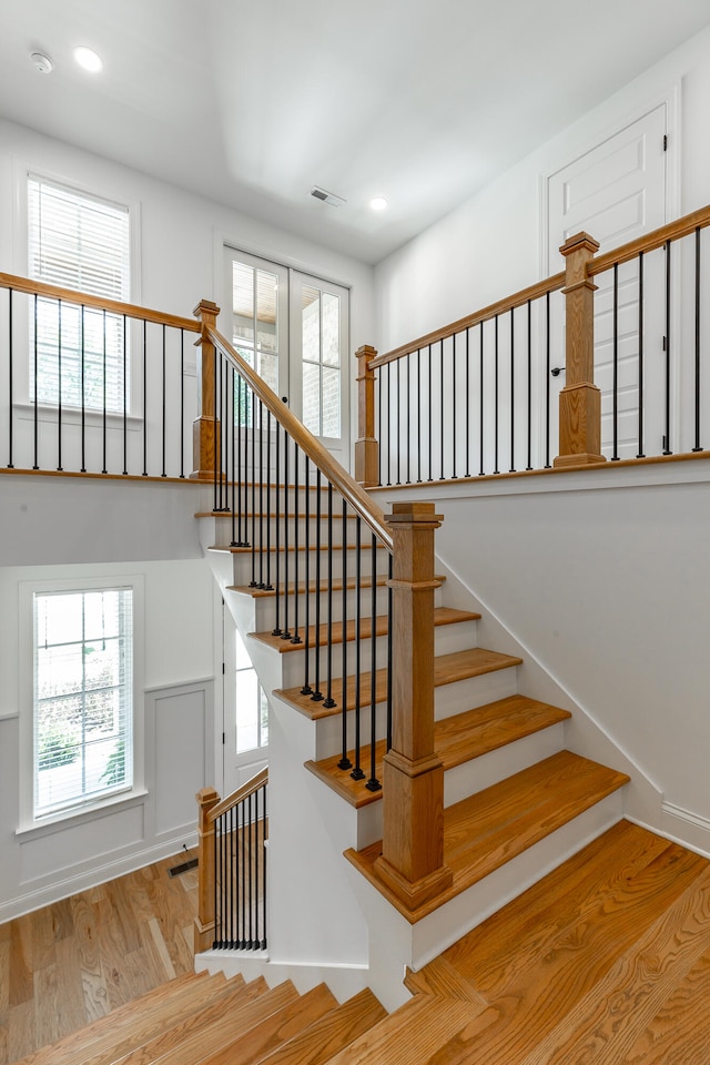 stairway with hardwood / wood-style flooring