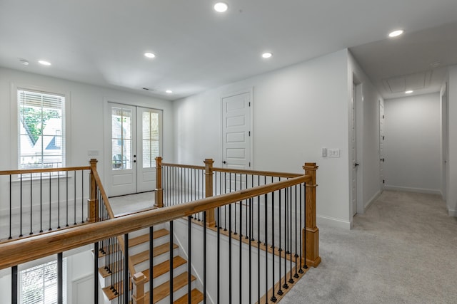 hallway featuring french doors and light colored carpet