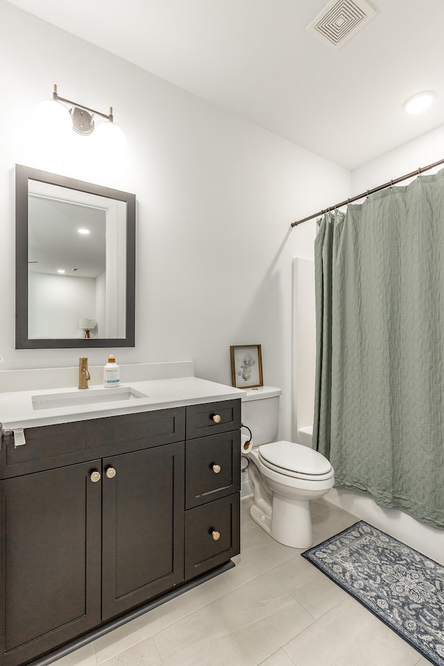 full bathroom featuring vanity, toilet, tile patterned floors, and shower / bath combination with curtain