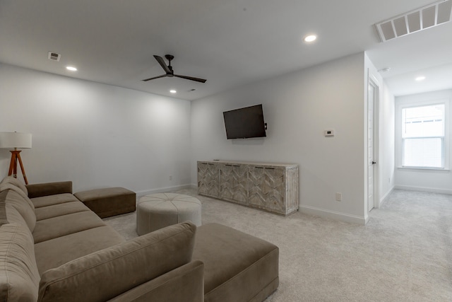 carpeted living room with ceiling fan