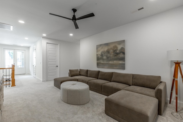 living room with light carpet, french doors, and ceiling fan