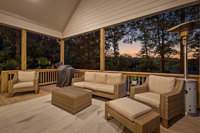 deck at dusk featuring an outdoor hangout area