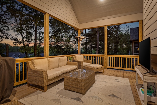 deck at dusk featuring an outdoor living space