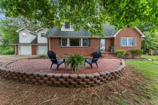 view of front of home featuring a garage and a patio