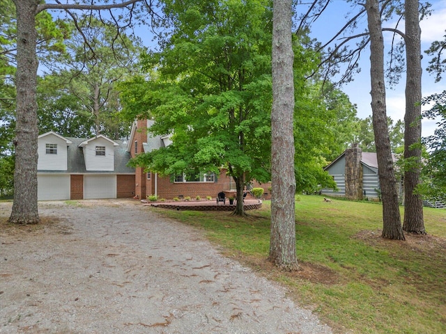 view of front of house featuring a garage and a front lawn