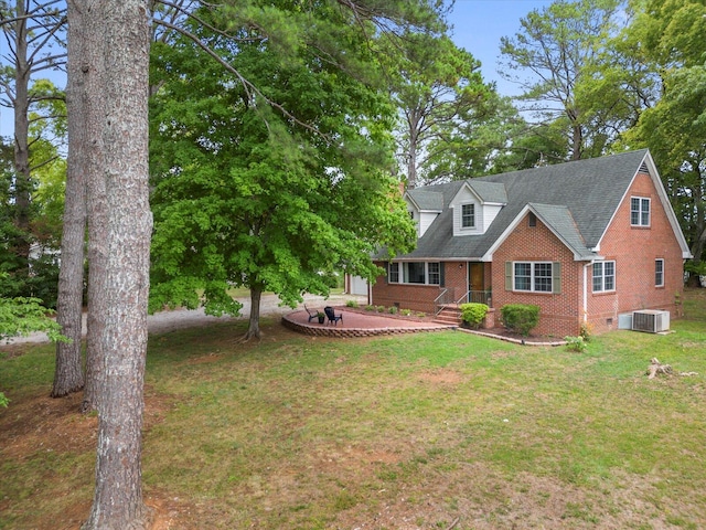 exterior space featuring a front yard and central AC