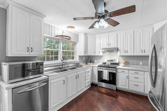 kitchen with white cabinetry, a textured ceiling, stainless steel appliances, ceiling fan, and dark wood-type flooring