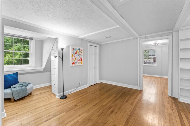 interior space featuring plenty of natural light, a textured ceiling, and light hardwood / wood-style flooring