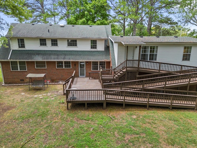 rear view of house with a yard and a deck