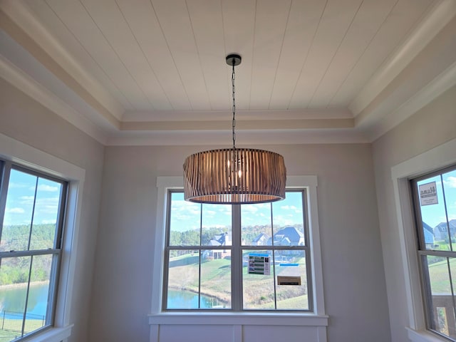 interior details with crown molding and a raised ceiling