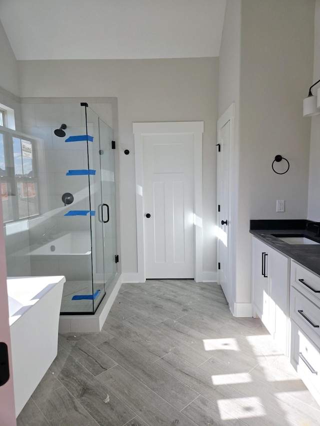 bathroom featuring vanity and plus walk in shower