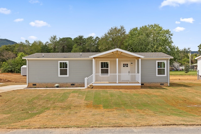 view of front of house with a front yard and a porch