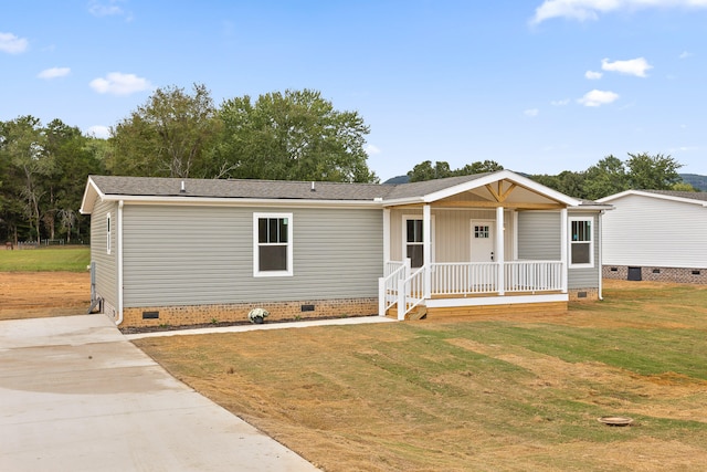 manufactured / mobile home with a front lawn and covered porch