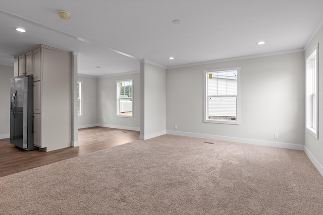 unfurnished room featuring wood-type flooring and crown molding