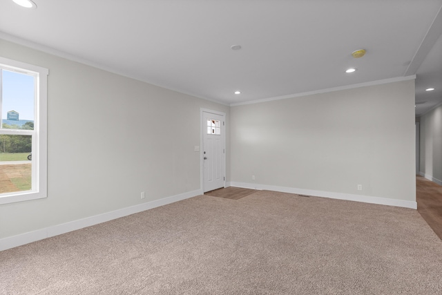 carpeted spare room with crown molding