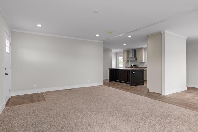 unfurnished living room featuring ornamental molding and wood-type flooring