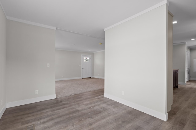 spare room featuring crown molding and hardwood / wood-style floors