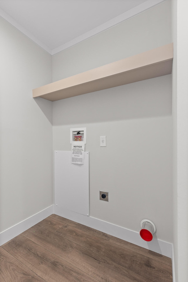 laundry room featuring dark wood-type flooring, hookup for an electric dryer, hookup for a washing machine, and ornamental molding