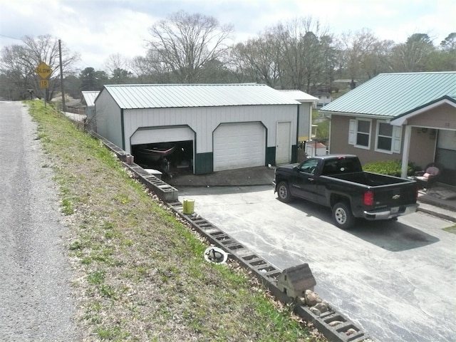 exterior space with a garage and an outdoor structure