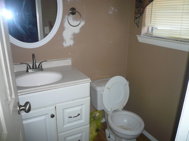 bathroom featuring vanity and toilet