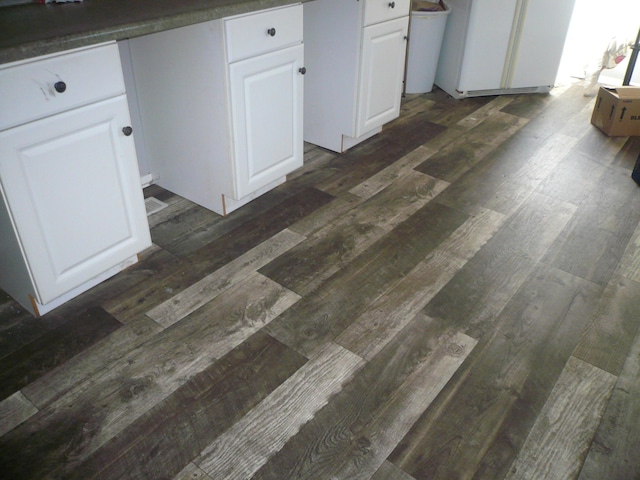 details with white cabinetry and dark hardwood / wood-style flooring