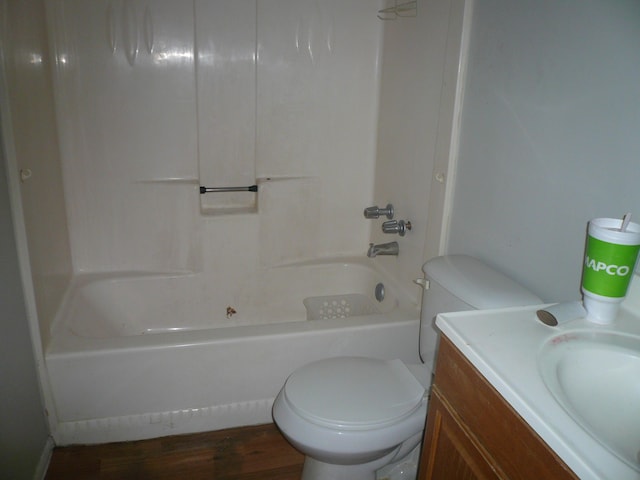 full bathroom with vanity, washtub / shower combination, hardwood / wood-style floors, and toilet