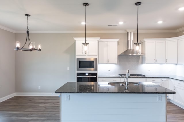 kitchen with wall chimney exhaust hood, stainless steel appliances, white cabinets, and hanging light fixtures