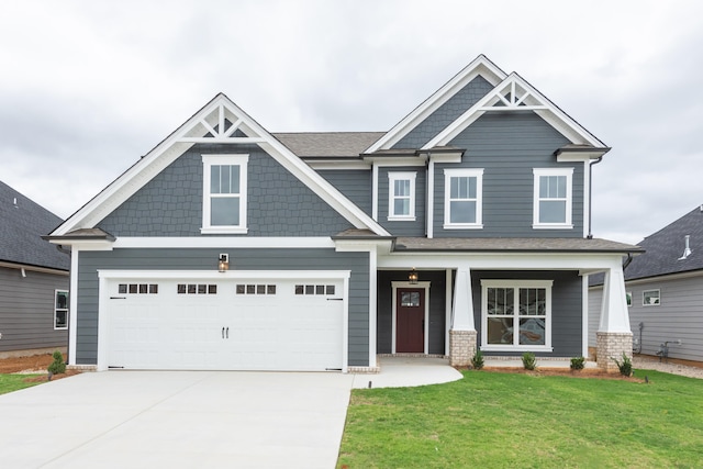 craftsman-style home with a front lawn, a porch, and a garage