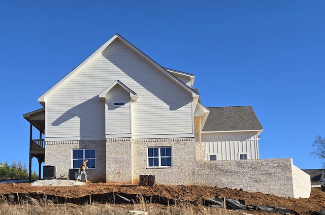 back of house with central AC and a balcony