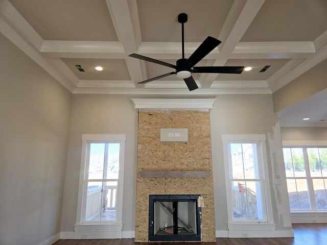 living room with coffered ceiling, ornamental molding, hardwood / wood-style flooring, ceiling fan, and beam ceiling