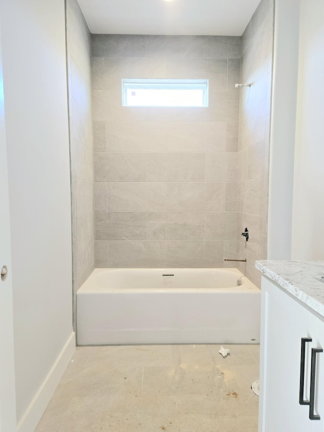 bathroom featuring vanity and tiled shower / bath combo