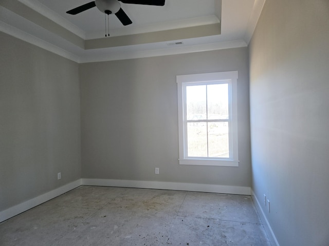 spare room with ceiling fan, ornamental molding, and a raised ceiling