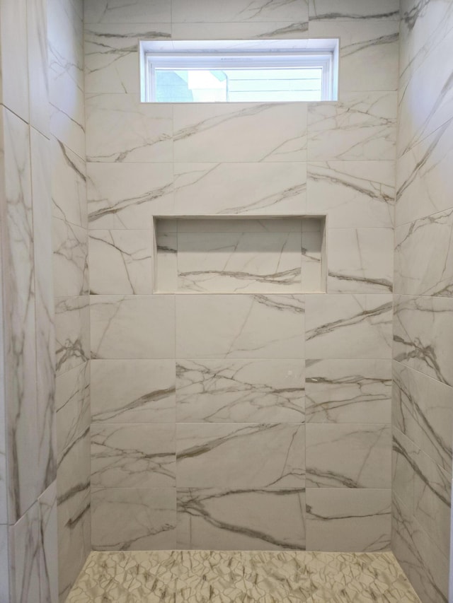 bathroom with tiled shower