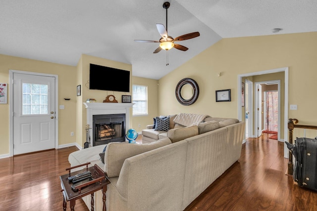 living room with dark wood-type flooring, lofted ceiling, and ceiling fan