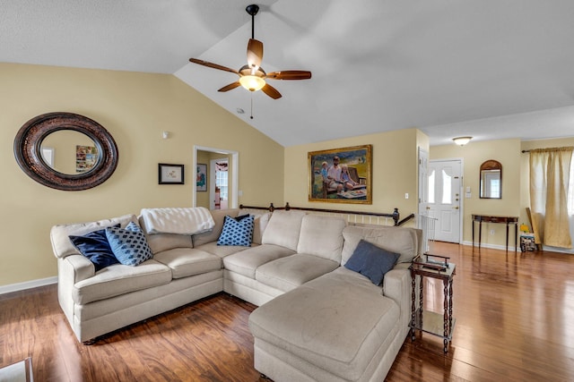 living room with dark hardwood / wood-style flooring, ceiling fan, and lofted ceiling