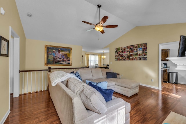 living room featuring dark wood-type flooring, ceiling fan with notable chandelier, and vaulted ceiling