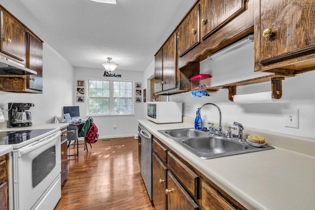 kitchen with a textured ceiling, wood-type flooring, sink, and white appliances