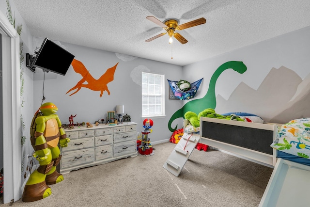 rec room with carpet flooring, ceiling fan, and a textured ceiling