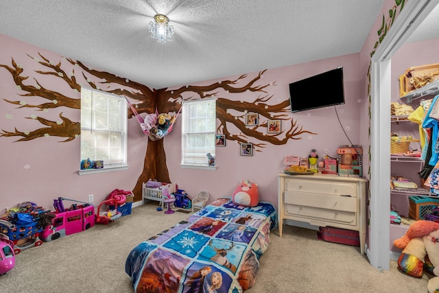 game room with a textured ceiling and carpet floors