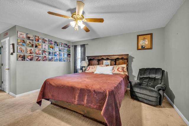 carpeted bedroom featuring a textured ceiling and ceiling fan