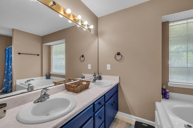 bathroom with a bathtub, plenty of natural light, and vanity