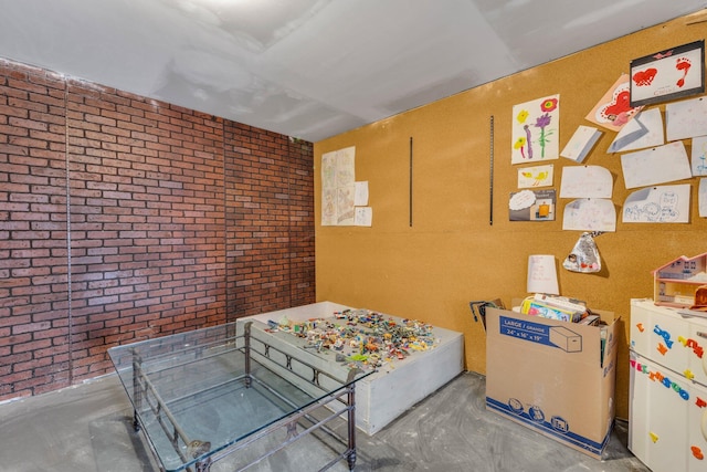 bedroom with brick wall and concrete floors