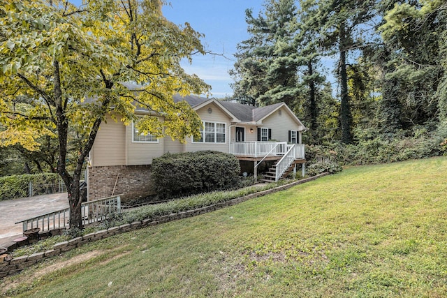 view of front of house with a front yard and a deck