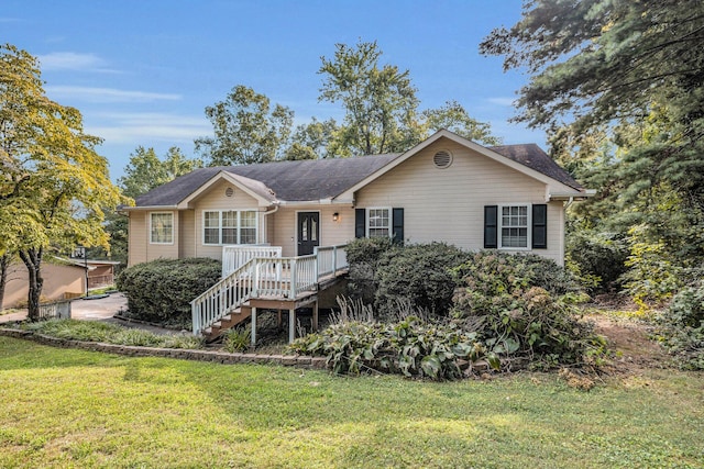 ranch-style home with a wooden deck and a front lawn