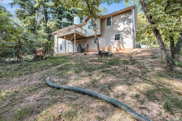 rear view of house featuring a wooden deck