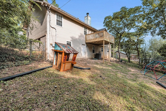 rear view of property featuring cooling unit and a deck