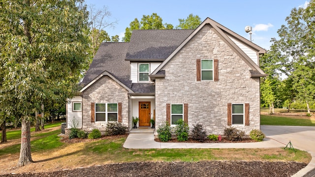 craftsman house with cooling unit and a front yard