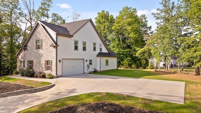 view of side of property with a yard and a garage