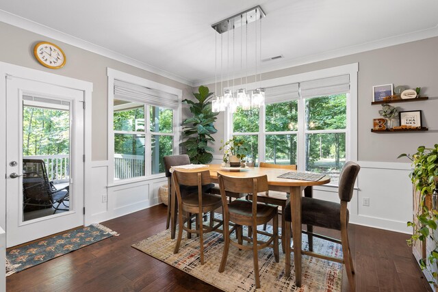 dining space with dark wood-type flooring and ornamental molding