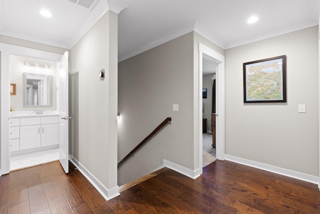 hallway featuring ornamental molding, dark wood-type flooring, and sink